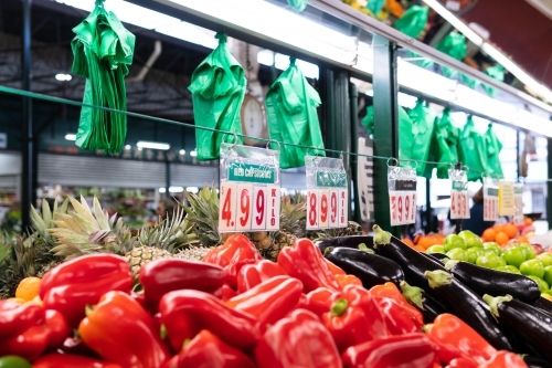 Plastic bags hanging on top of a food stall in the market. - Australian Stock Image