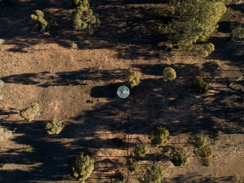 Plastic water storage tank in dry farm paddock - Australian Stock Image