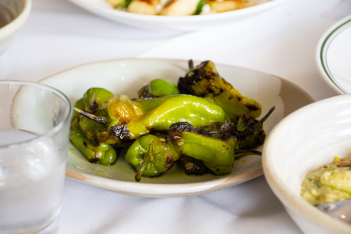 Plate of green peppers on a dining table - Australian Stock Image