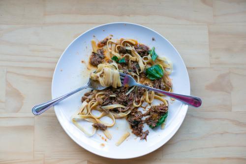 plate of pasta with fork and spoon - Australian Stock Image