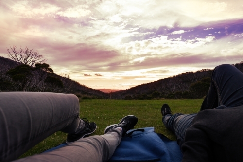 Point of view of couple lying on a rug watching the sunset