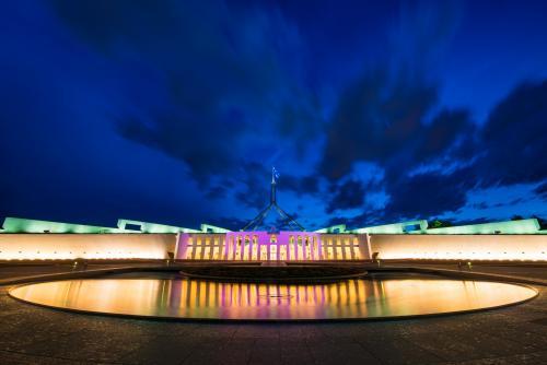Pool of reflection at night in front of Parliament House Canberra - Australian Stock Image