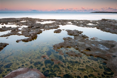 Pools on rock platform at sunset - Australian Stock Image