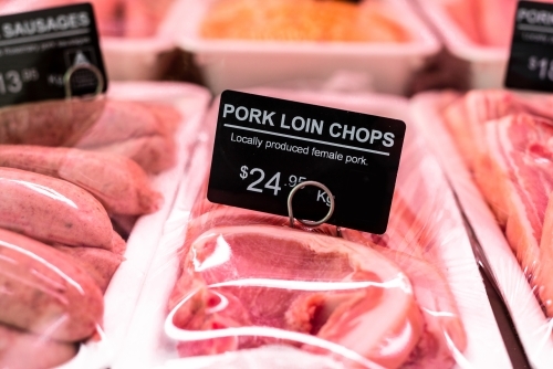 pork chop sign in butcher shop on fresh pork chop - Australian Stock Image