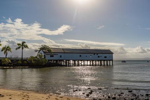 Port Douglas Sugar Wharf jutting into the bay on stilts - Australian Stock Image