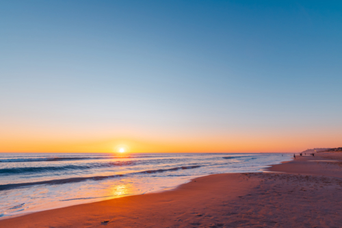 Port Noarlunga beach with fishermen at sunset, South Australia - Australian Stock Image