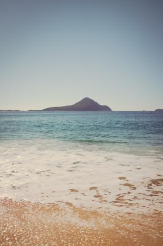 Port Stephens beach on the NSW Mid North Coast. Focus on bubbles in foreground - Australian Stock Image