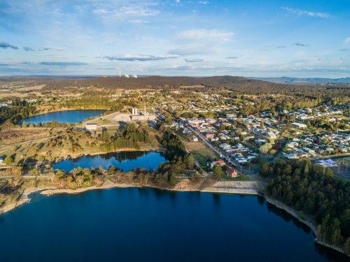 Portland mill pond with cement works and church beside town - Australian Stock Image