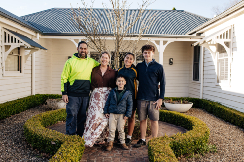 Portrait if a family with mixed ethnicity outside home - Australian Stock Image