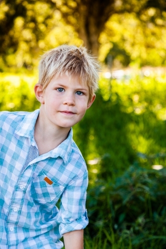portrait of a child outside with copy space and neutral expression - Australian Stock Image