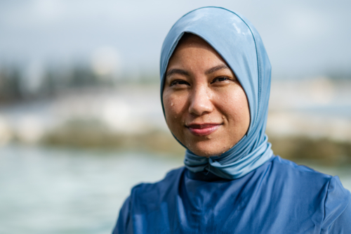 Portrait of a Filipino woman on the beach on a sunny day - Australian Stock Image
