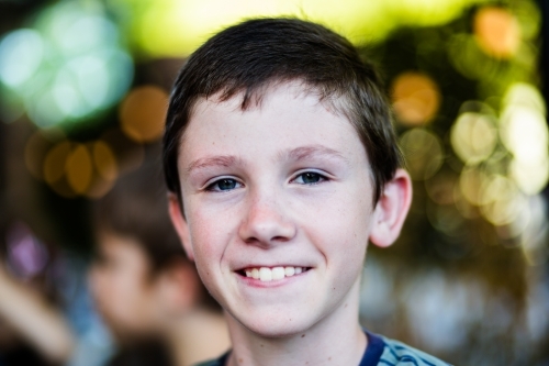 Portrait of a happy eleven year old boy with blurred background - Australian Stock Image