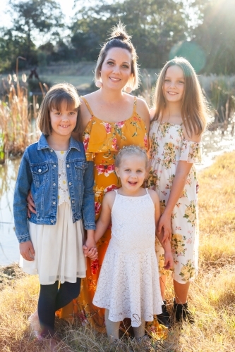 Portrait of a happy mother with her young daughters - Australian Stock Image