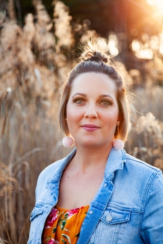 Portrait of a happy thirty something year old woman outside - Australian Stock Image