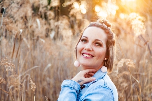 Portrait of a happy thirty something year old woman outside - Australian Stock Image