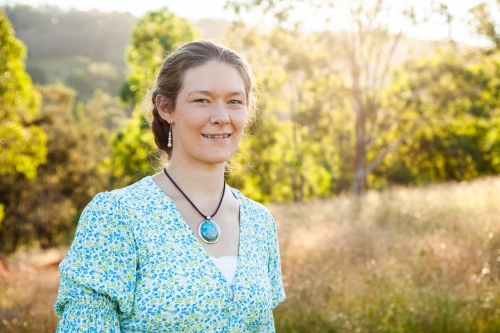 Portrait of a happy woman outside in paddock - Australian Stock Image