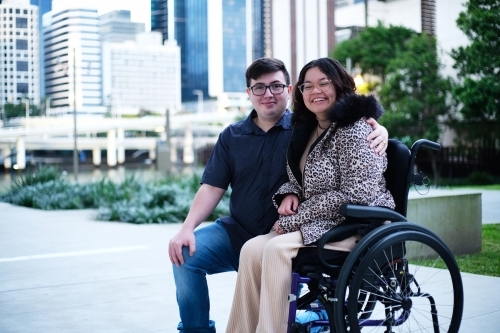 Portrait of a man a woman with a disability in wheel chair sitting outside - Australian Stock Image