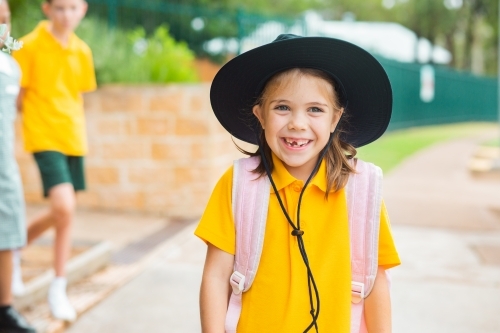 Portrait of a smiling young Australian school girl with bag ready to go back to school - Australian Stock Image