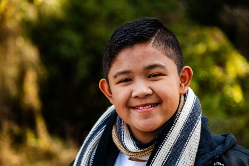 Portrait of a tween boy wearing scarf in winter - Australian Stock Image