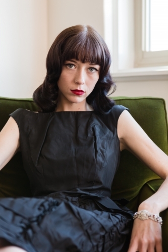 Portrait of a young brunette woman with retro styled hair - Australian Stock Image