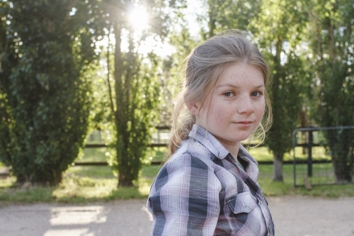 Portrait of a young girl at horse riding farm