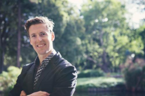 Portrait of a young professional man in a leafy green city park - Australian Stock Image