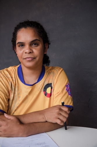 Portrait of Aboriginal woman with a grey background - Australian Stock Image