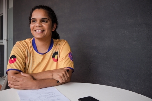 Portrait of Aboriginal woman with pen and paper - Australian Stock Image