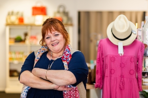 portrait of business owner standing in boutique clothes shop for plus size people