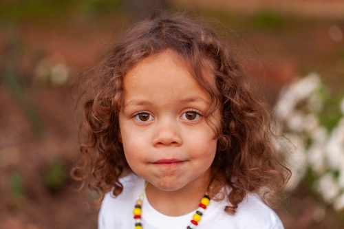 Portrait of curly haired Australian three year old child of aboriginal ethnicity