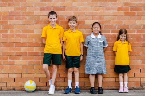Portrait of four happy school friends at an Australian public school - Australian Stock Image