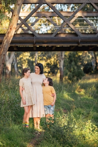 Portrait of mother and children standing together in Australian bush setting - Australian Stock Image