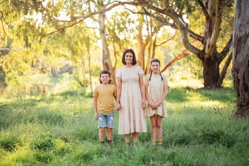 Portrait of mother and children together in Australian bush setting - Australian Stock Image