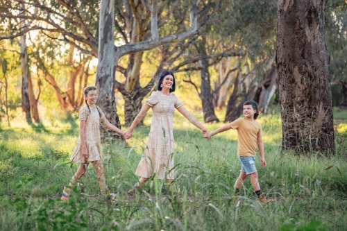 Portrait of mother and children walking together in Australian bush setting - Australian Stock Image