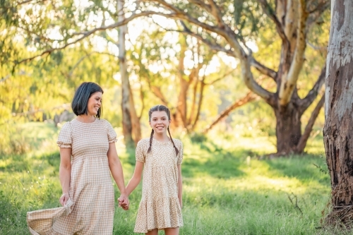 Portrait of mother and daughter standing together in Australian bush setting - Australian Stock Image
