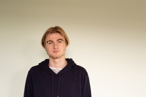 Portrait of teenage boy wearing black hoodie - Australian Stock Image