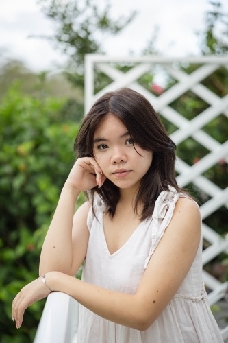 Portrait of teenage girl leaning on railing - Australian Stock Image