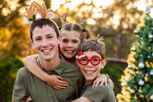 Portrait of three happy Aussie kids at Christmas time in Australia - Australian Stock Image