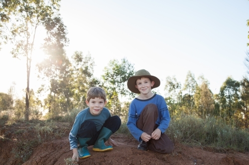 Portrait of two happy Aussie kids with copy space in rural australian landscape - Australian Stock Image