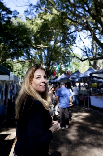 Portrait of woman standing in the middle of an outdoor marketplace - Australian Stock Image