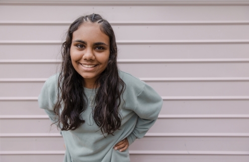 Portrait of young Aboriginal woman leaning forward - Australian Stock Image