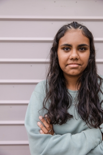 Portrait of young Aboriginal woman with folded arms - Australian Stock Image
