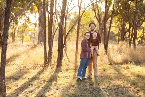 Portrait of young australian family in bushland with copy space - Australian Stock Image
