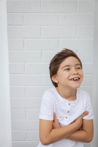 Portrait of young boy against white wall