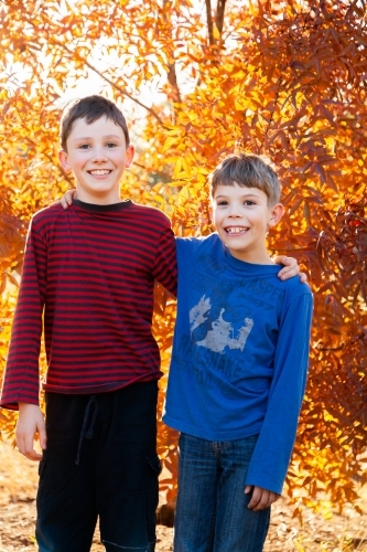 Portrait of young brothers laughing together in autumn - Australian Stock Image