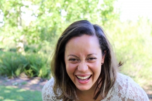 Portrait of young female outdoors with trees in background - Australian Stock Image