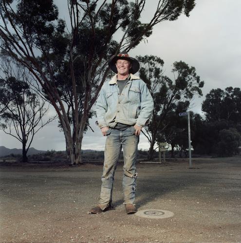 Portrait of young male rural worker standing on street in remote loaction - Australian Stock Image
