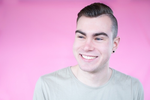Portrait of young man on plain background - Australian Stock Image