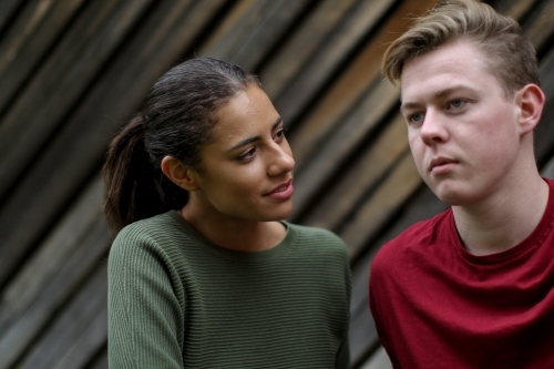 Portrait of young mixed race couple in serious conversation - Australian Stock Image