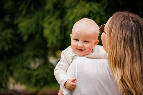 Portrait of young mum and small happy baby in the park - Australian Stock Image